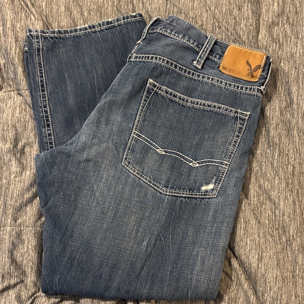 American Eagle Men's Dark Blue Relaxed Denim Jeans with Leather Logo Patch